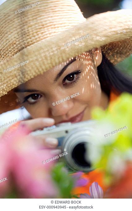 Young Woman Taking Pictures of Flowers