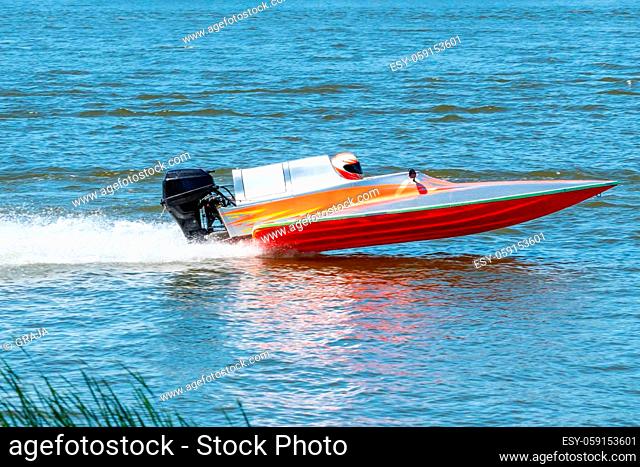 Speed boat go fast along the lake in powerboat competition