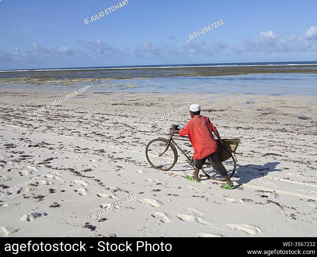 Local man and bicycle on the beach at Tiwi, on Indian Ocean coast, Kenya