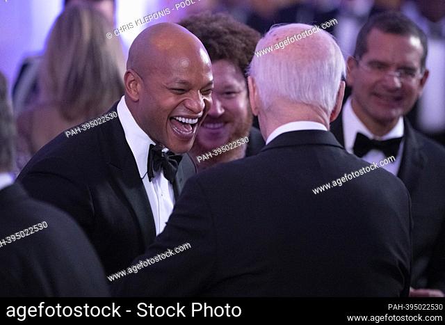 Governor Wes Moore (Democrat of Maryland) speaks with United States President Joe Biden as they arrive for an after dinner party for Governors and their spouses...