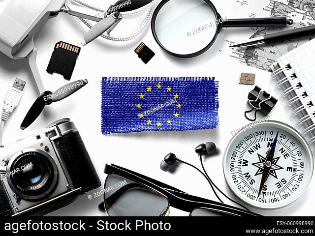Flag of European Union and travel accessories on a white background. The view from the top