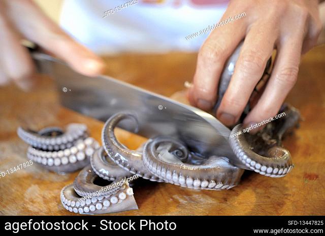 An octopus being sliced