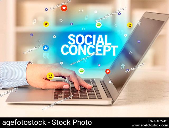 Freelance woman using laptop with SOCIAL CONCEPT inscription, Social media concept