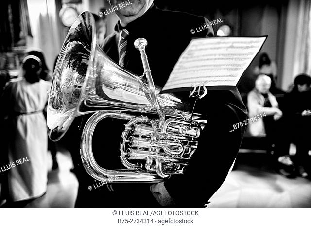 Detail of unrecognizable musician with tubasheet music during Holy Week celebrations, Mahon, Menorca, Baleares, Spain