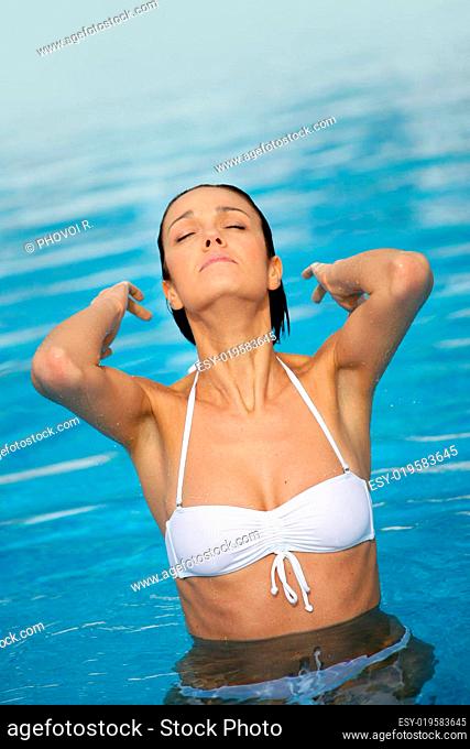 woman in a swimsuit at the swimming pool closed eyes profile