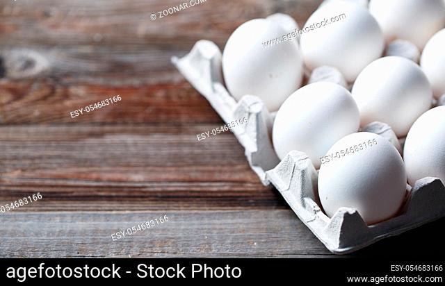 White eggs on a rustic wooden table
