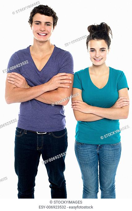 Confident teen with their arms crossed isolated against white background