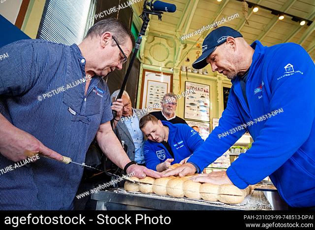 29 October 2023, Mecklenburg-Western Pomerania, Heringsdorf: World record - Largest Bismark herring roll is produced in the store of fish sommelier and...
