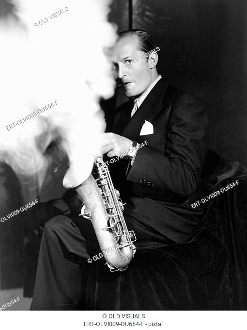 Musician blowing smoke out of a saxophone