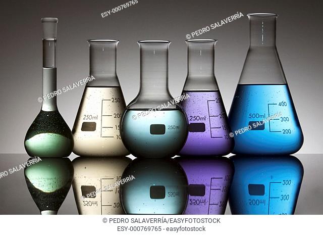 still life of five laboratory flasks photographed backlit