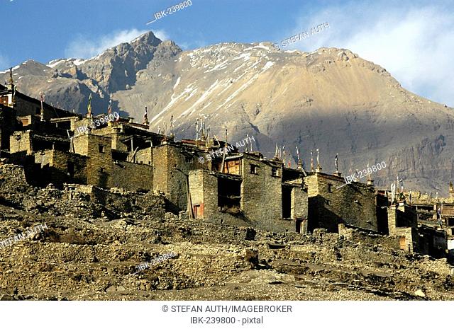 Nested Houses made of stones with flat roofs with mountain massive in the background Nar Nar-Phu Annapurna Region Nepal