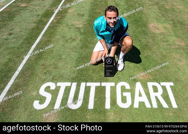13 June 2021, Baden-Wuerttemberg, Stuttgart: Tennis: ATP Tour - Stuttgart, Singles, Men, Final. Marin Cilic of Croatia takes part in the award ceremony after...