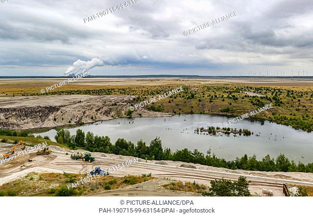 15 July 2019, Brandenburg, Cottbus: Work is currently underway on the future quay wall, on the edge of the former Cottbus-Nord opencast lignite mine