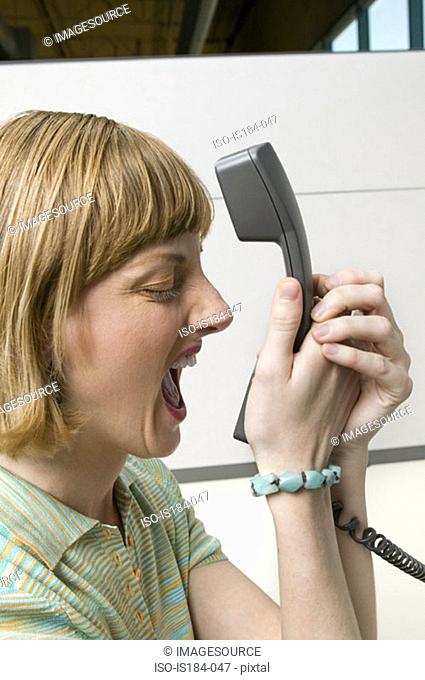 Office worker shouting into telephone