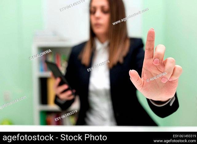 Businesswoman Holding Cellphone And Pointing New Ideas With One Finger
