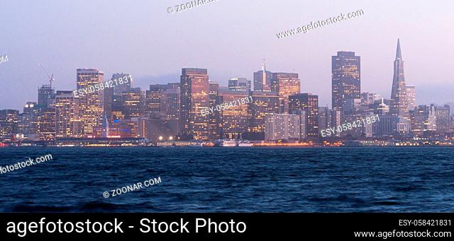 Common mist and fog hangs over the San Francisco skyline after sunset