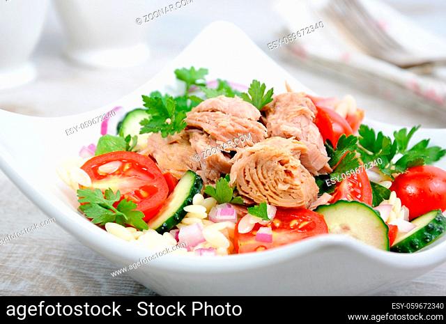 Salad from canned tuna with tomatoes, cucumber and orzo