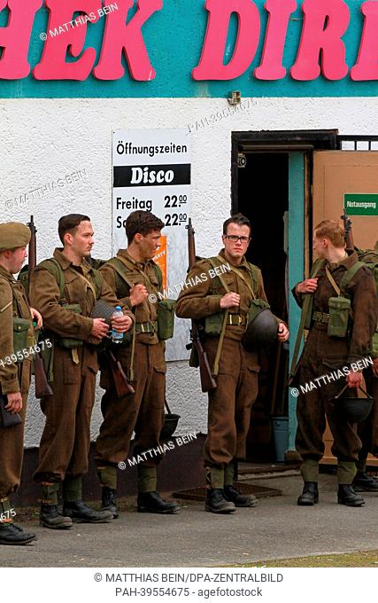 Extras stand in front of a discothek in Osterwieck, Germany, 16 May 2013. Amercan actor George Clooney is filming his movie 'The Monuments Men' in Osterwieck at...