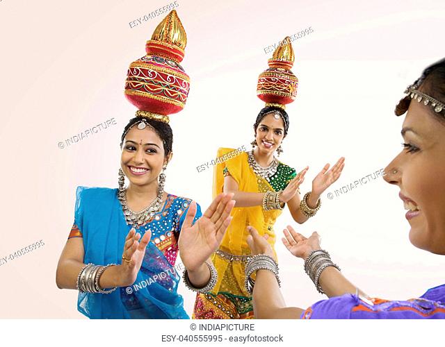 Gujarati women dancing with a kalash on their head