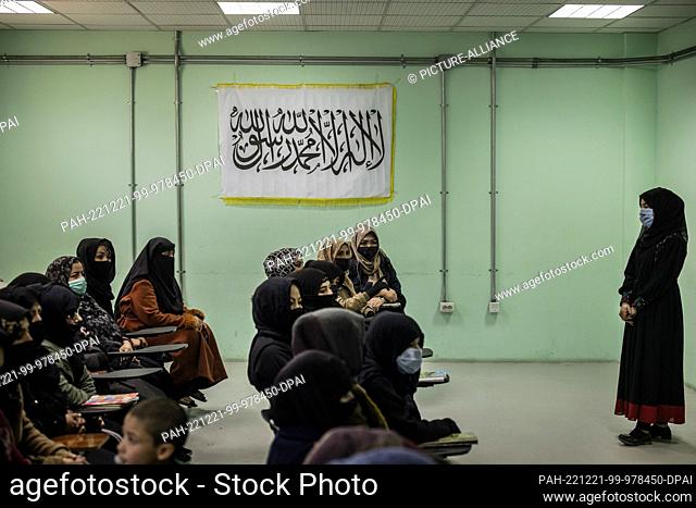 17 November 2022, Afghanistan, Kabul: Women are trained as police officers in a classroom at a police barracks draped in the Taliban's flag with the Islamic...