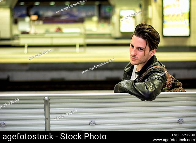 Attractive young man inside modern building, station or airport