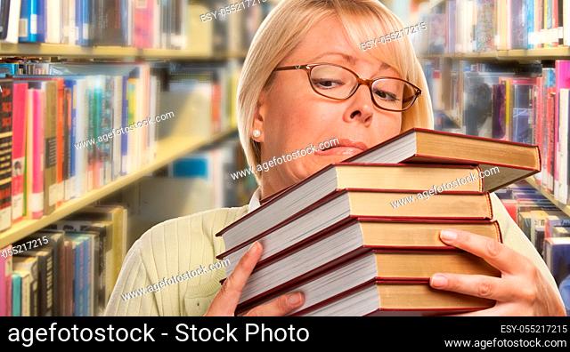 Beautiful Expressive Student or Teacher with Books in Library