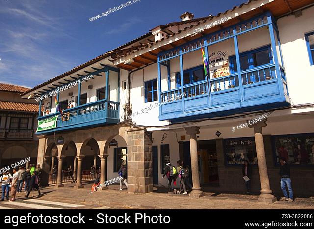 View to the colonial buildings with balconies used as cafe-restaurant in Plaza De Armas at the historic center, Cusco, Peru, South America