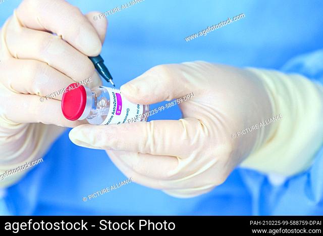 25 February 2021, Rhineland-Palatinate, Mainz: A vial of Corona vaccine from AstraZeneca is labeled at a police vaccination center at the vaccination launch