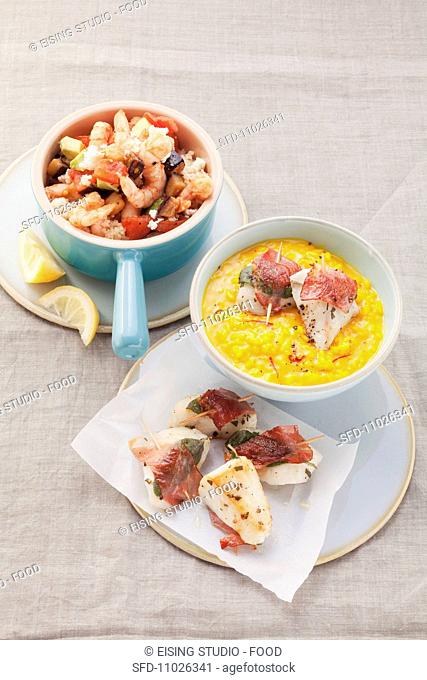 Shrimp with vegetables, sheep's cheese and couscous and pollock with ham and sage on saffron risotto