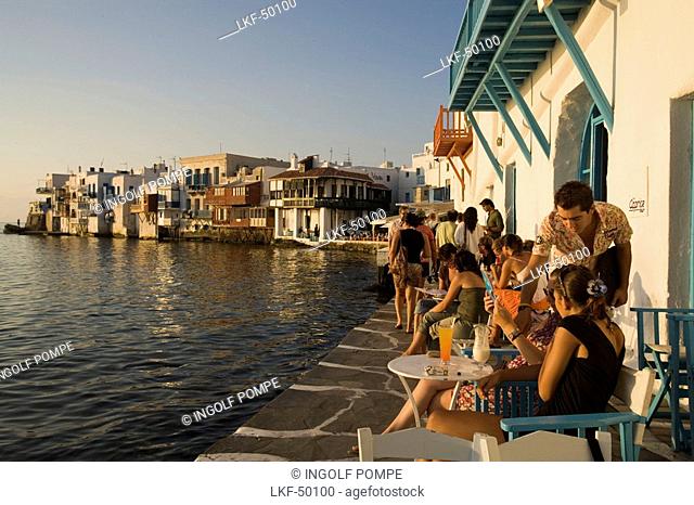 People sitting in the Caprice Bar directly at sea, Little Venice, Mykonos-Town, Mykonos, Greece