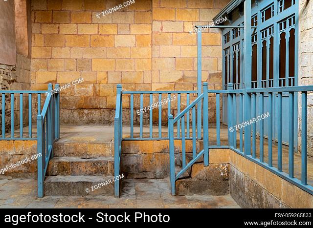 Abandoned historic traditional bathhouse (Hamam Inal) with staircase leading to bricks stone wall, wooden blue balustrade, and doors of changing rooms