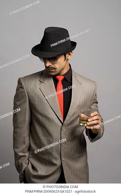 Actor portraying a businessman holding a wineglass