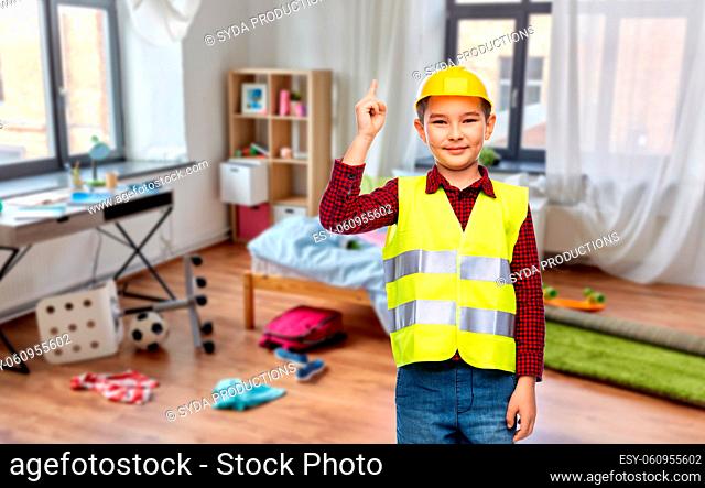 little boy in protective helmet pointing finger up
