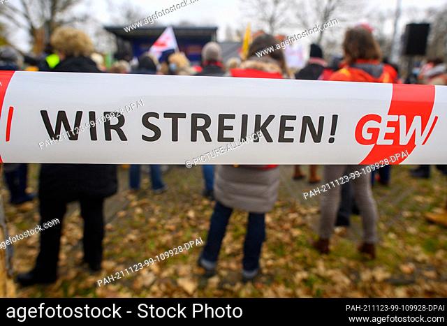 23 November 2021, Saxony-Anhalt, Magdeburg: ""We are on strike!"" can be read on a barrier tape during a warning strike in front of the Ministry of Finance of...