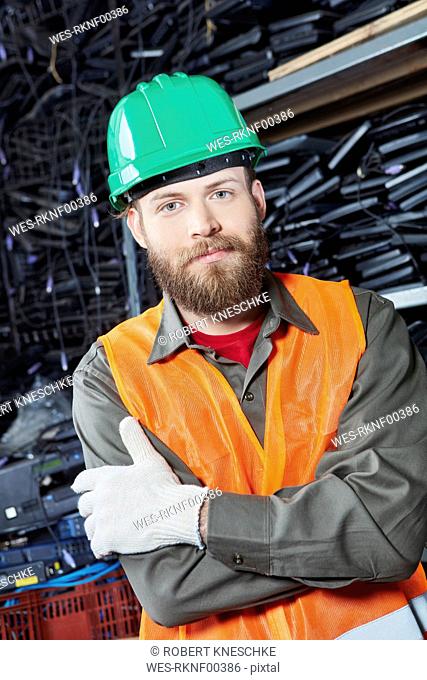 Worker in computer recycling plant, portrait