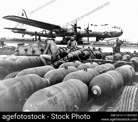 Saipan Superforts Prepared For Tokyo Attack Ground, crewmen prepare bombs for loading into a 3-29 Superfortress, the ""Dauntless Dotty"" at the new American air...