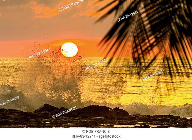 Sun going down behind surf spray at this resort near Mal Pais, southern Nicoya Peninsula, Santa Teresa, Puntarenas, Costa Rica, Central America