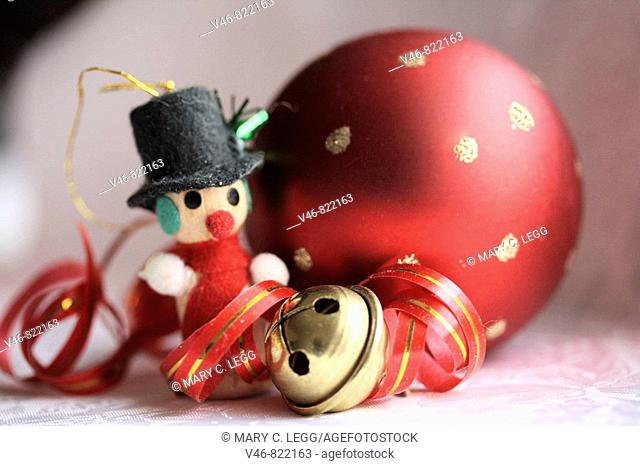 Miniature snowman, red Christmas ball and jingle bell with curled ed and gold ribbon