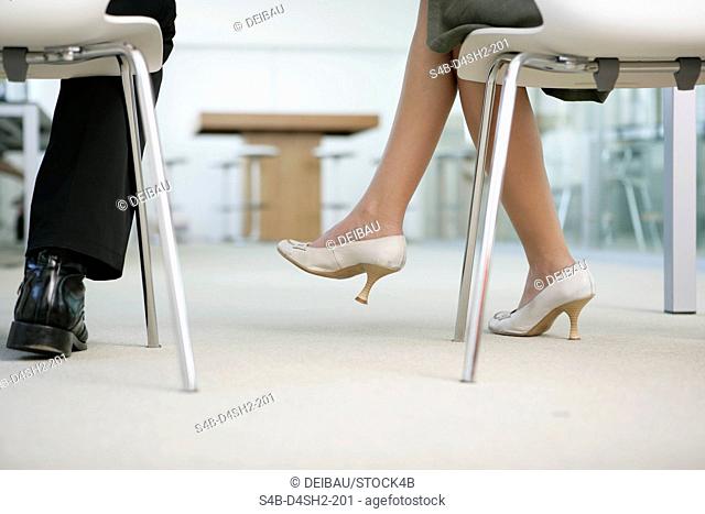 Feet of two businesspeople, selective focus