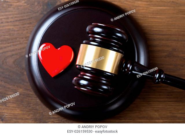 High angle view of mallet and heart on table in courtroom
