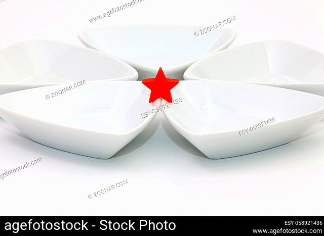 Ceramic bowls for sushi food and red star on the white table