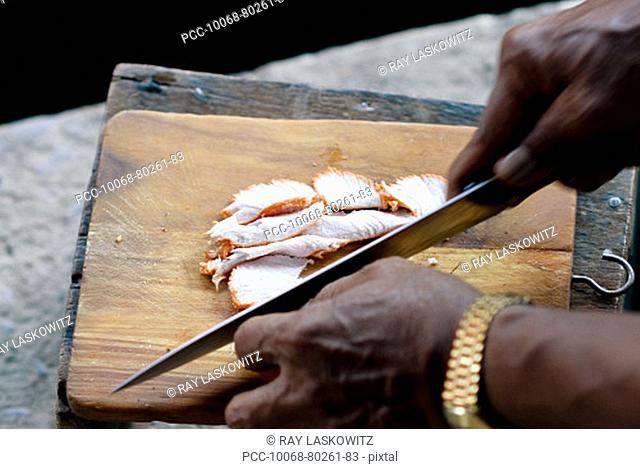 Thailand, Bangkok, Close-up of hands chopping meat on a cutting board