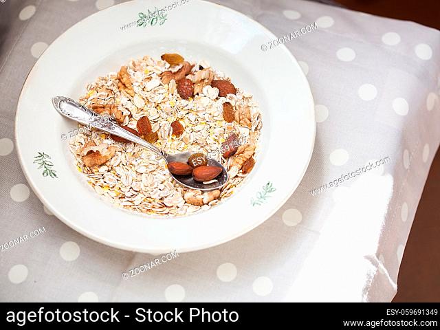 Oatmeal in bowl with nuts, useful food