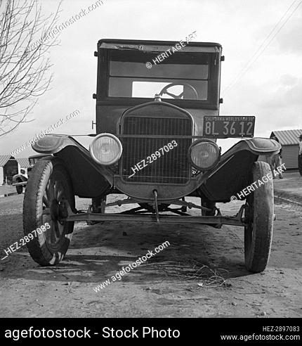 Model T Fords still carry migrants, FSA migratory labor camp at Farmersville, California , 1939. Creator: Dorothea Lange