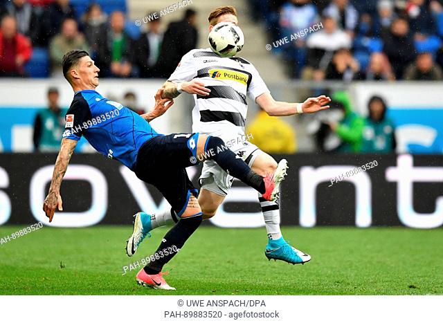 Moenchengladbach's Andre Hahn and Hoffenheim's Steven Zuber (L) vie for the ball during the German Bundesliga soccer match between 1899 Hoffenheim and Borussia...