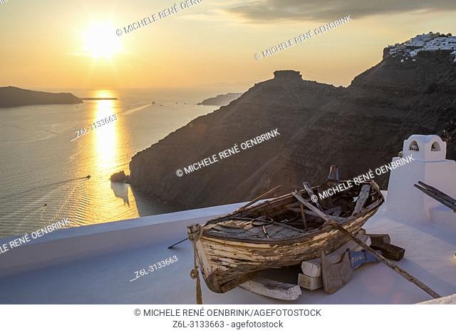 Scenic overlook of old row boat at sunset in Thira, Fira, Santorini Greece