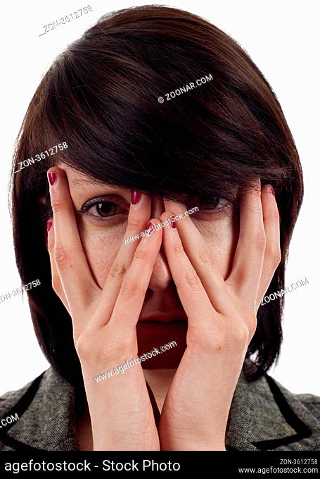 Closeup of a sad woman covering up her face with her hands