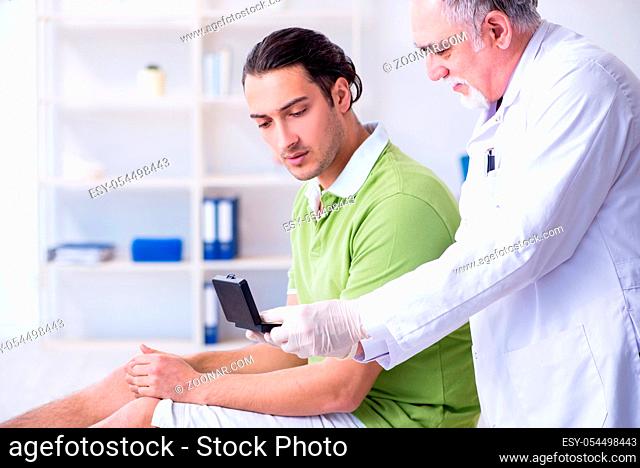 Male patient with hearing problem visiting doctor otorhinolaryngologist