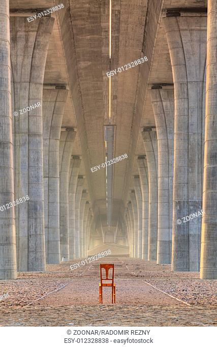 Abandoned chair under the highway bridge