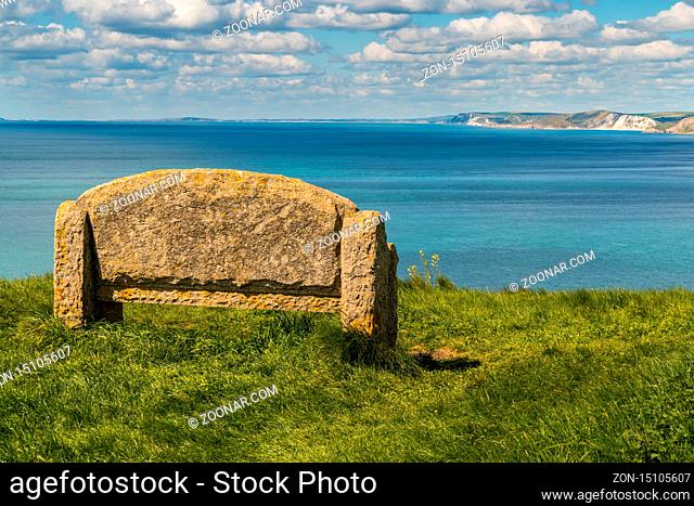 Stone bench at the South West Coast Path with a view over the Jurassic Coast, near Worth Matravers, Jurassic Coast, Dorset, UK